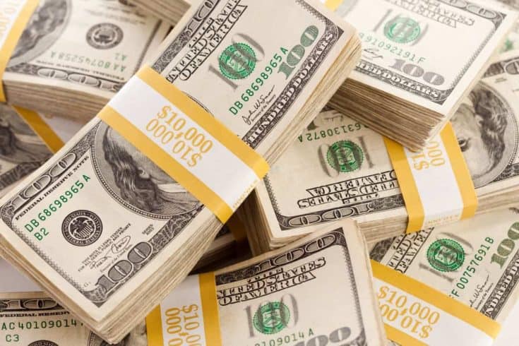 stacks of hundred dollar bills wrapped in ten thousand dollar increments