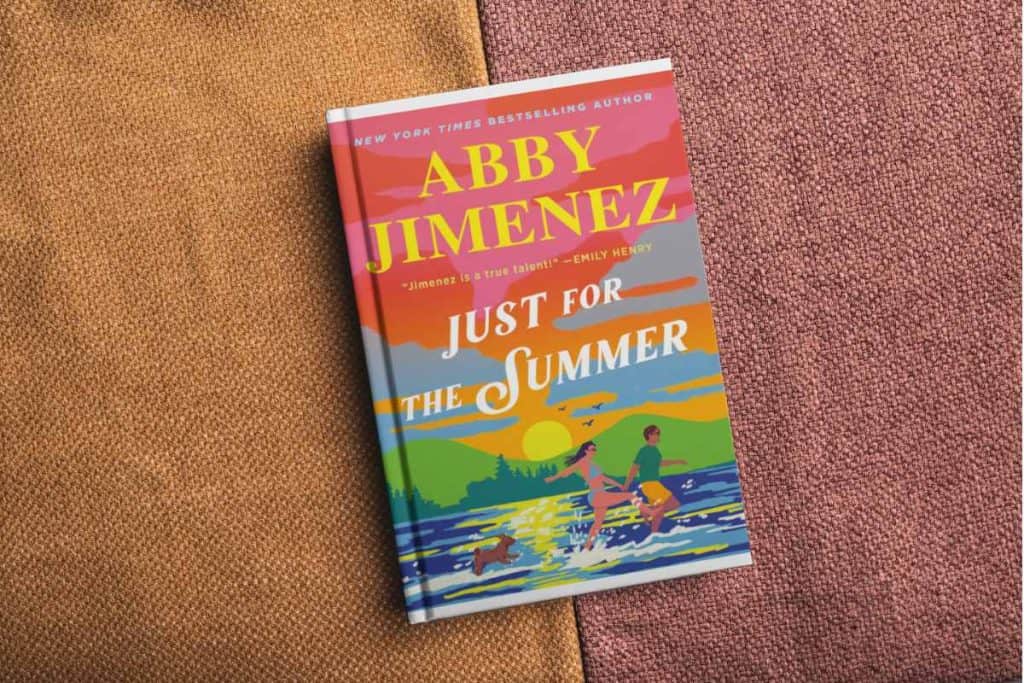 Book titled "Just For The Summer" sitting on a couch cushion