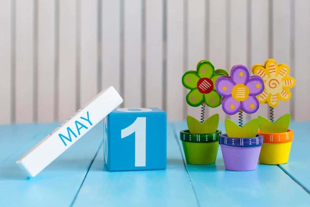 Colorful wooden flower decorations with a block calendar turned to May 1