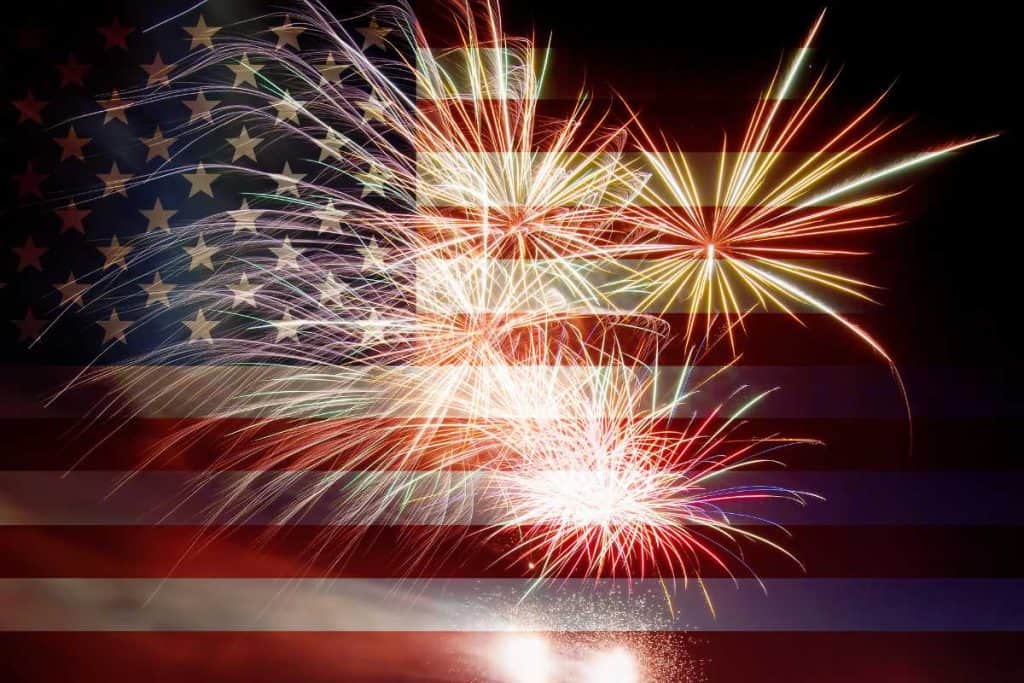 The American flag in the background with fireworks imposed in front of it