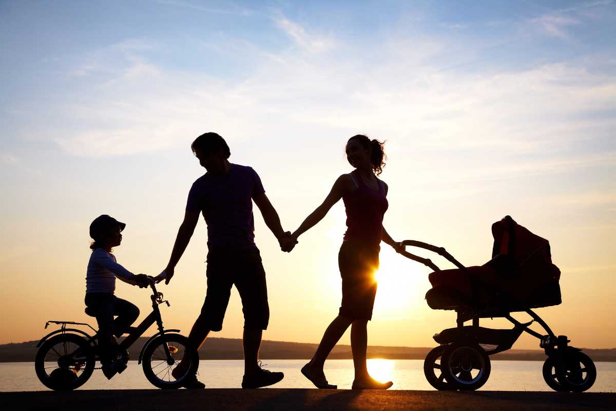 Silhouette of a family walking along the beach