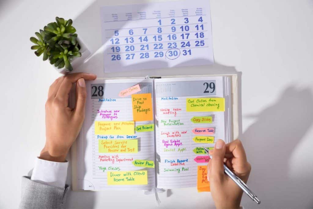Open calendar and agenda book with all kinds of notes in different color inks