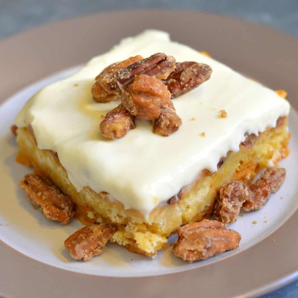a slice of Pumpkin Crunch Cake dessert with candied pecans on top