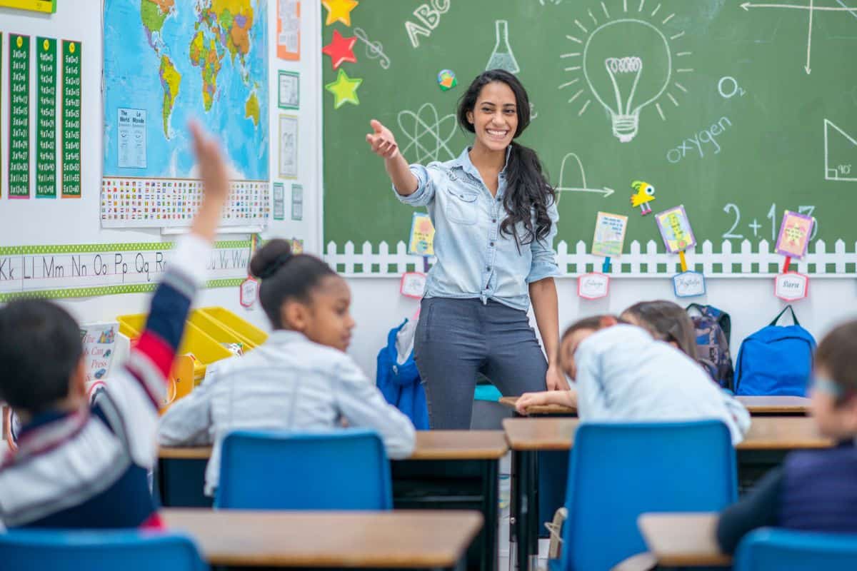 Teacher calling on a student during instruction in an elementary school classroom