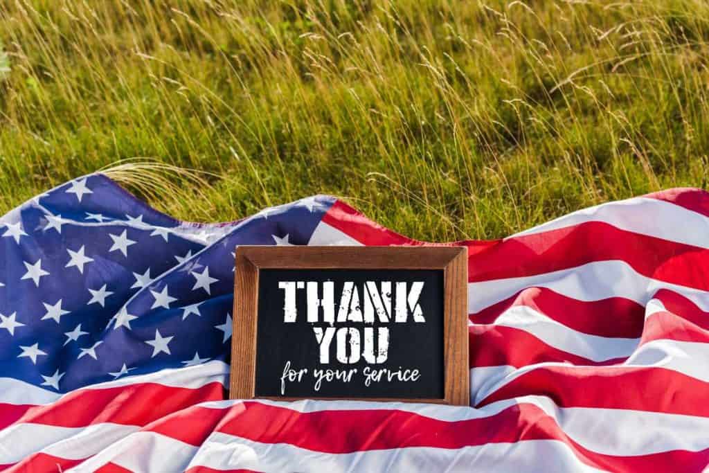 An American Flag with a "Thank you for your service" message in a frame for Veterans Day