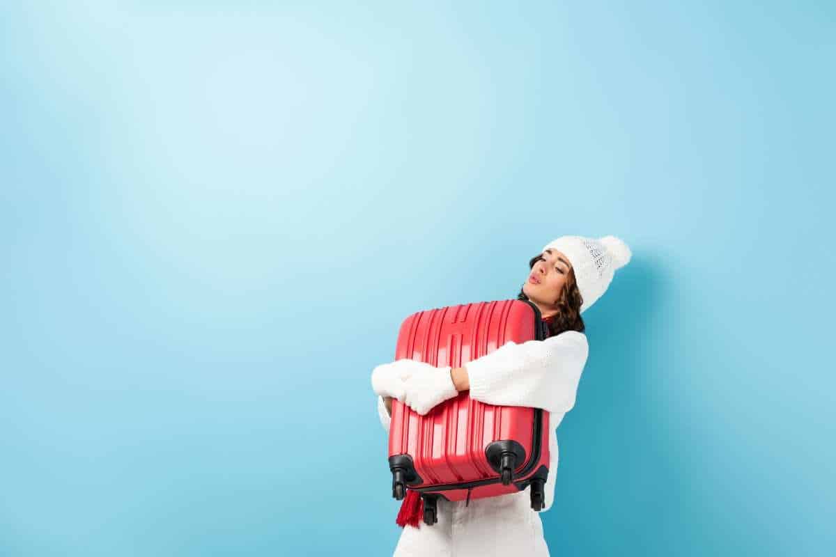 A woman hugging her suitcase