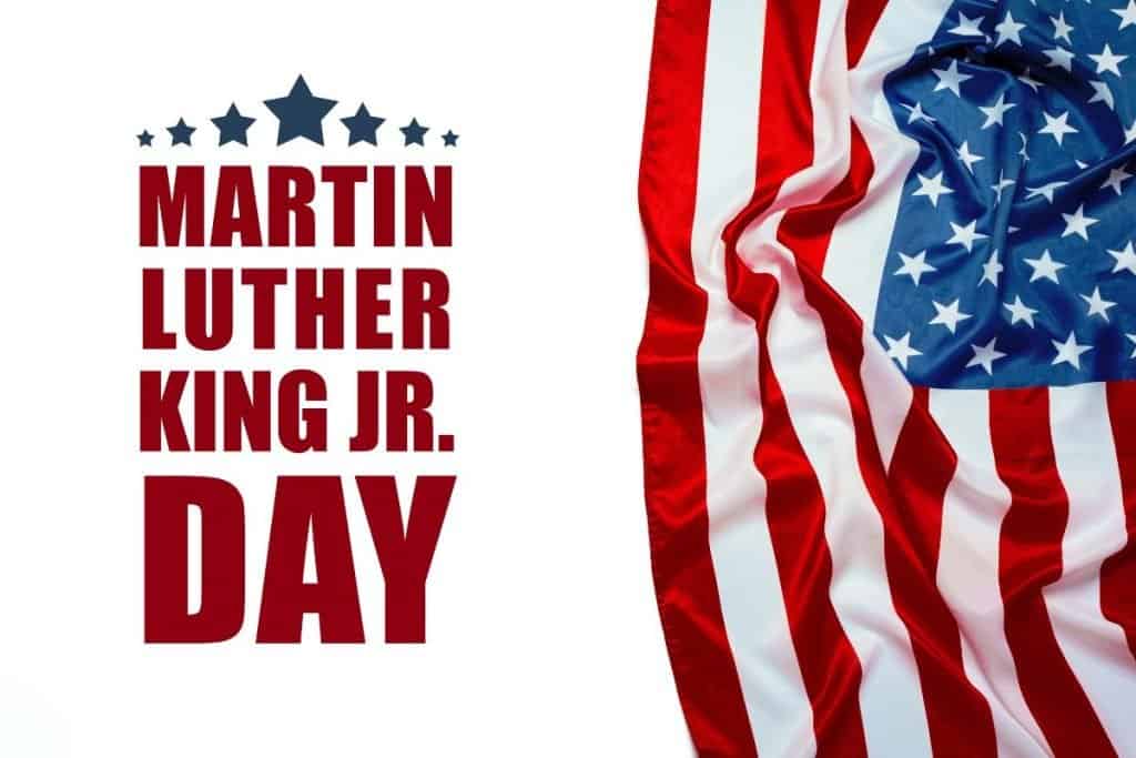 An American flag with the caption of "Martin Luther King Jr Day"
